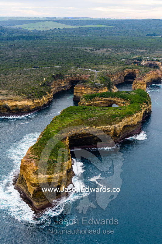 An aerial view of the ocean and the erosion on the sheer limestone cliffs and bays. Twelve Apostles, Port Campbell National, Great Ocean Road, Victoria, Australia.