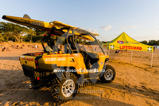 A quad bike rescue vehicle on the beach with surfboards for life savers. Mindil Beach Sunset Markets, Darwin, Northern Territory, Australia.