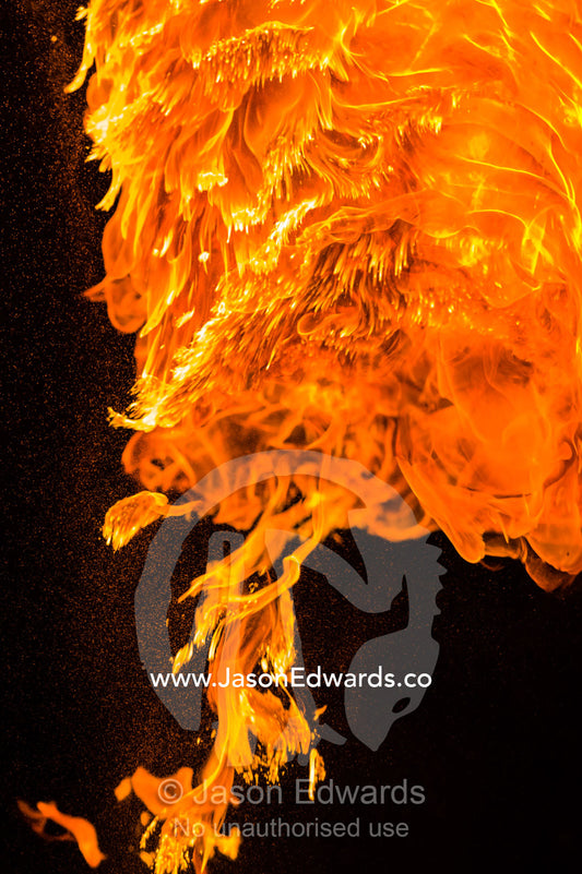 A ball of fire from a fire performer throwing a flaming baton. Mindil Beach Sunset Markets, Darwin, Northern Territory, Australia.