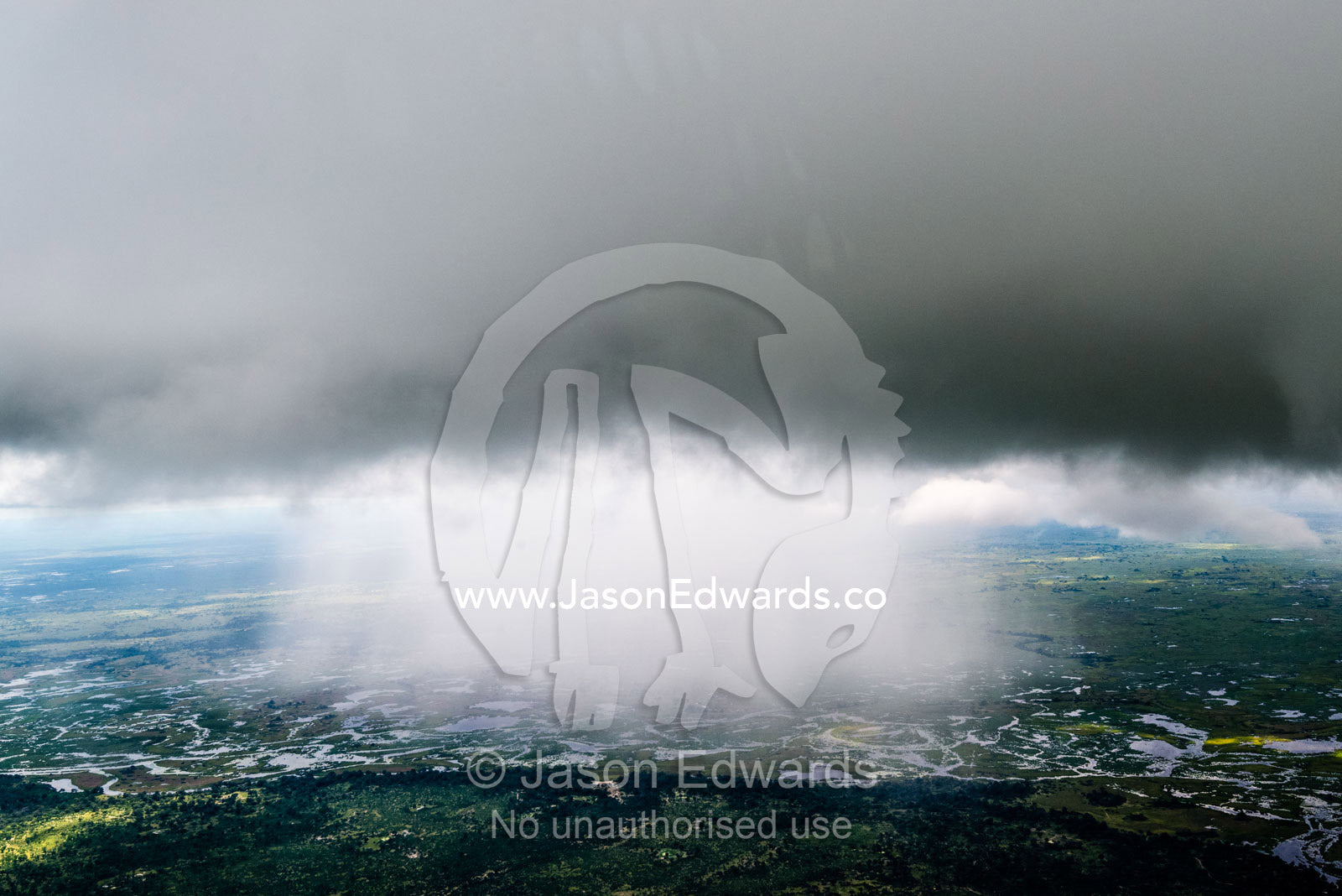 An aerial view of a rain storm flooding a wetland and river system. Chobe National Park, Botswana.