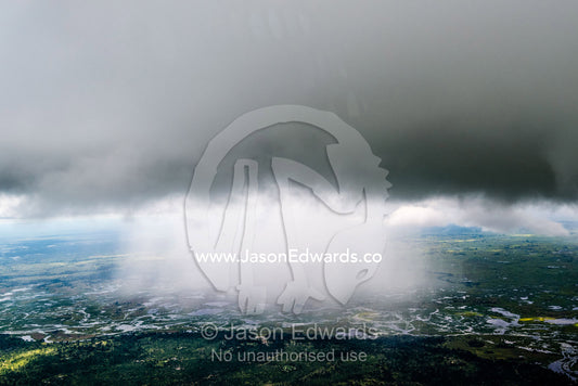 An aerial view of a rain storm flooding a wetland and river system. Chobe National Park, Botswana.