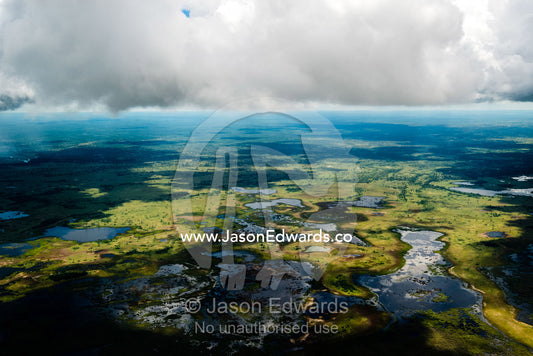 A storm gathers over the rivers, streams and waterholes of a floodplain. Okavango Delta, Botswana.