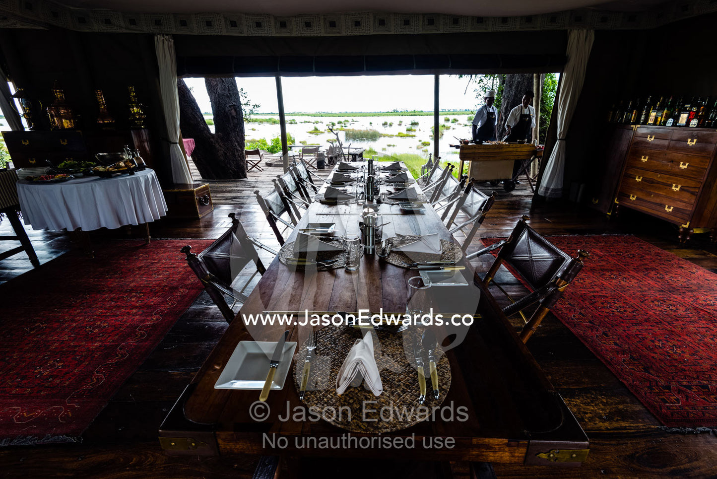 An elegant dining table set for a luncheon in a tented safari camp. Zarafa Camp, Zibadianja Lagoon, Savute Channel, Linyanti, Botswana.