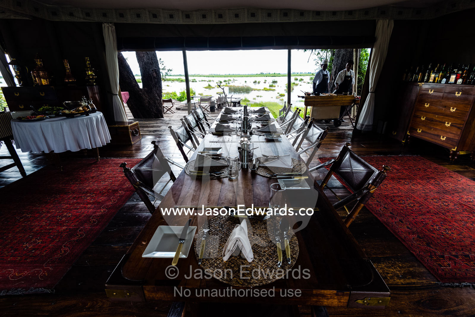 An elegant dining table set for a luncheon in a tented safari camp. Zarafa Camp, Zibadianja Lagoon, Savute Channel, Linyanti, Botswana.