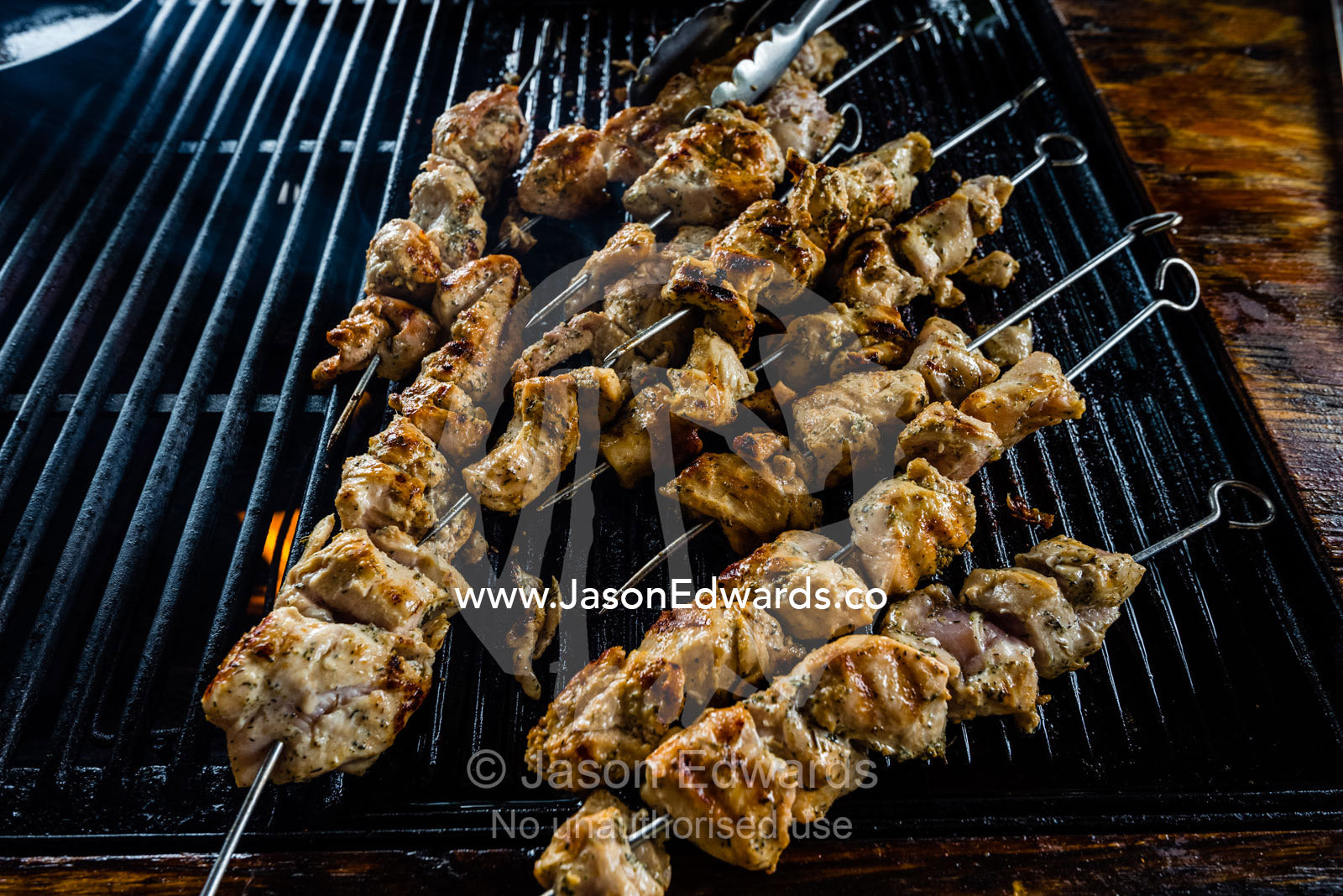 Chicken skewers on a barbecue grill in a African safari camp. Zarafa Camp, Zibadianja Lagoon, Savute Channel, Linyanti, Botswana.