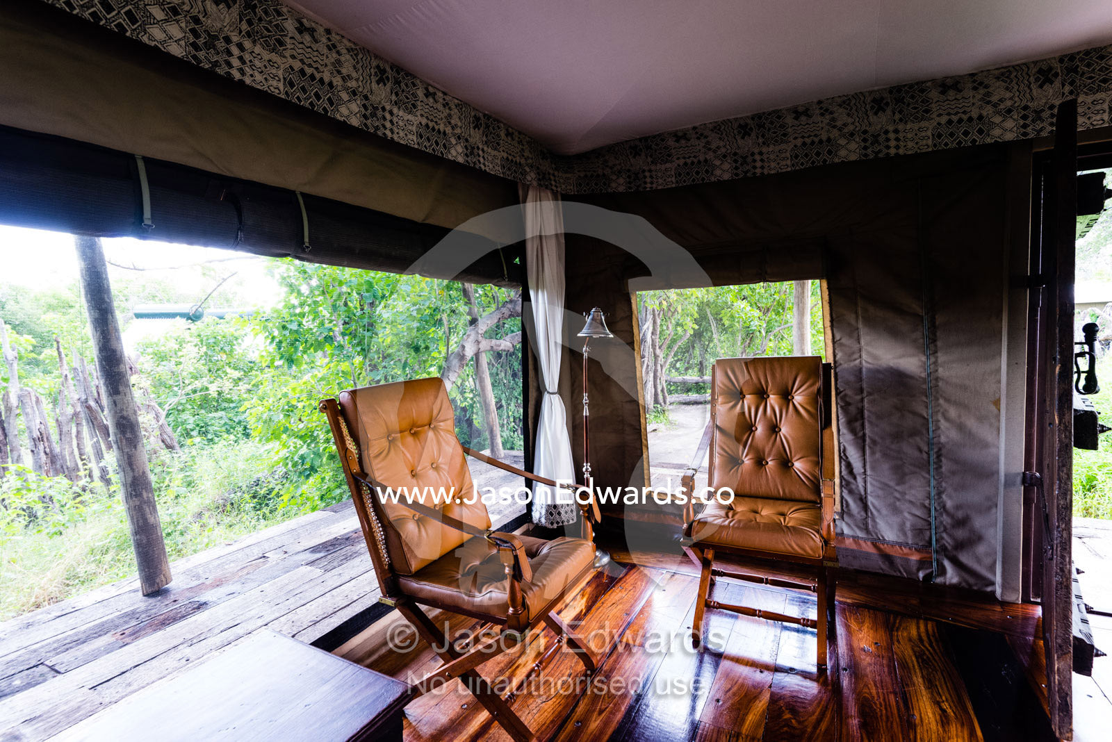 Antique leather camping chairs in the sitting room of a luxurious tented safari camp. Zarafa Camp, Zibadianja Lagoon, Savute Channel, Linyanti, Botswana.