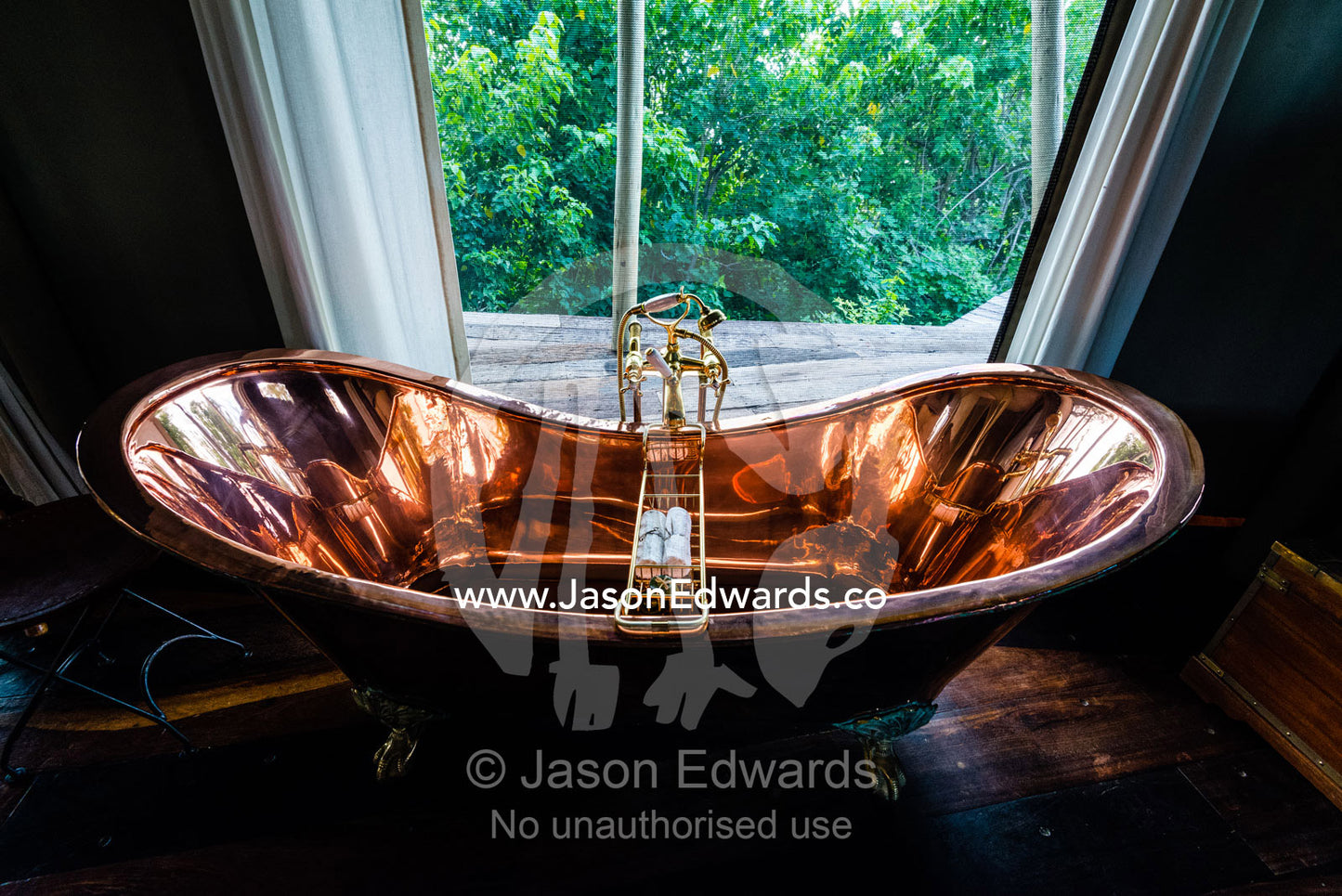 A polished copper bath in a luxurious safari camp tent. Zarafa Camp, Zibadianja Lagoon, Savute Channel, Linyanti, Botswana.