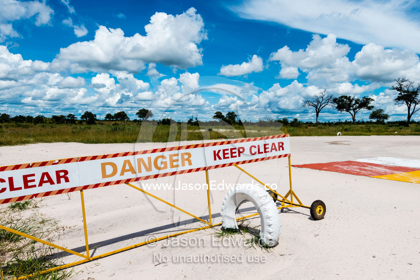 A portable warning sign on a bush airstrip. Selinda Reserve, Linyanti Region, Northern Botswana.