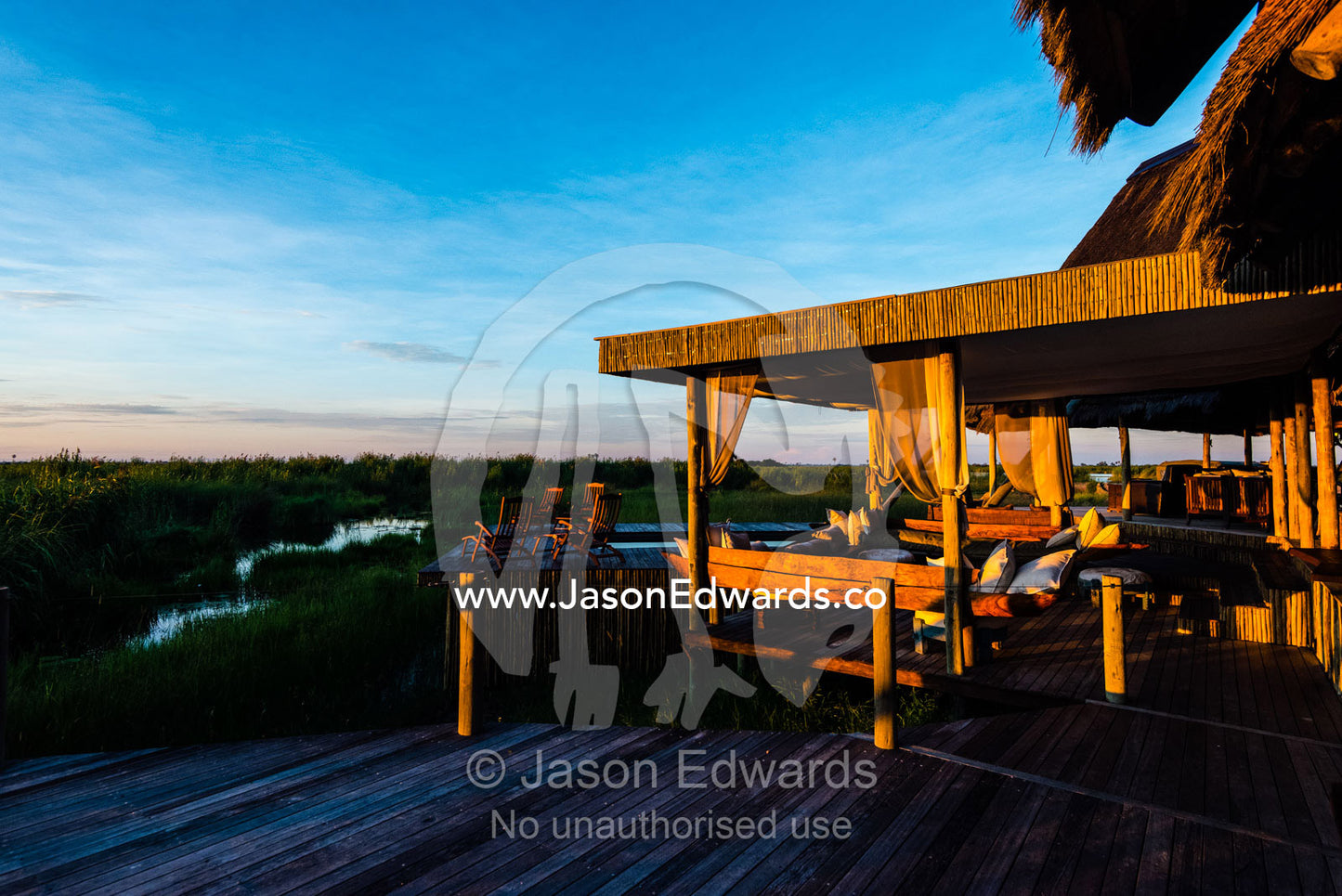 A luxury safari camp overlooking a wetland at dawn. Selinda Camp, Selinda Reserve, Linyanti Region, Northern Botswana.