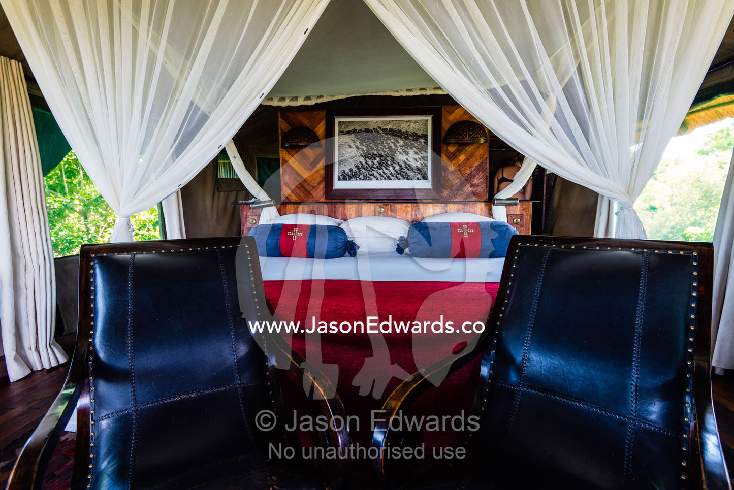 A mosquito net around a bed in a luxurious safari camp tent. Selinda Camp, Selinda Reserve, Linyanti Region, Northern Botswana.