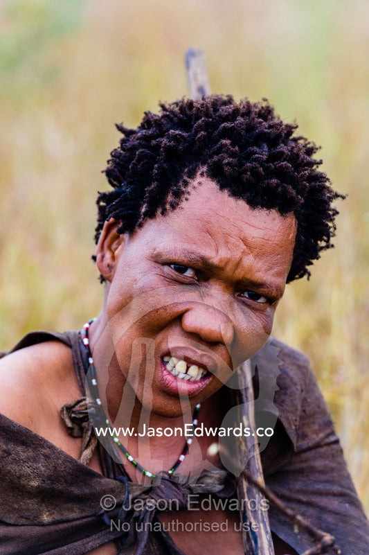 A portrait of a San Bushmen woman wearing leather animal skins. Kalahari Desert, Botswana.