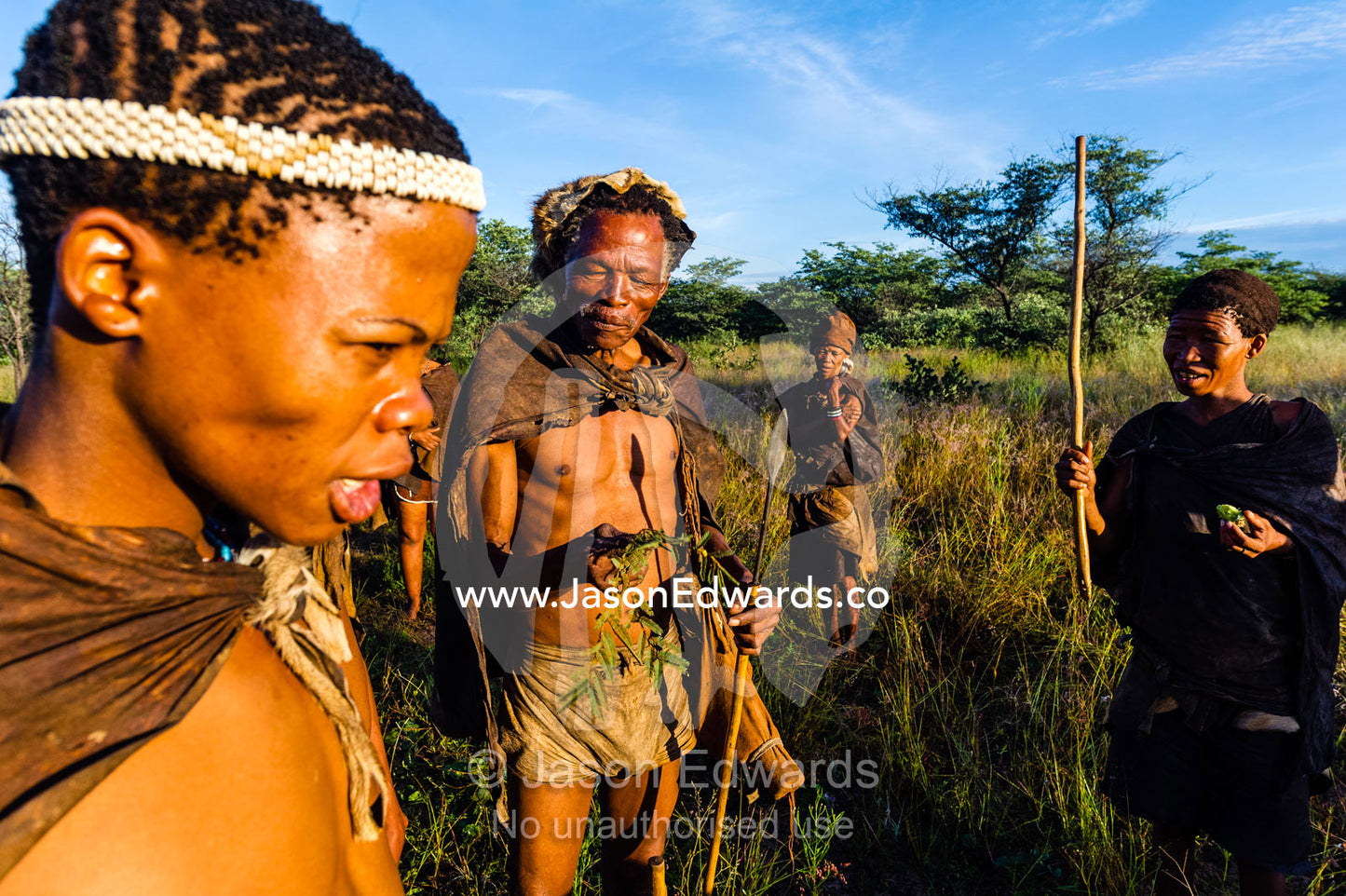 A young San Bushmen wearing an Ostrich egg shell head band. Kalahari Desert, Botswana.