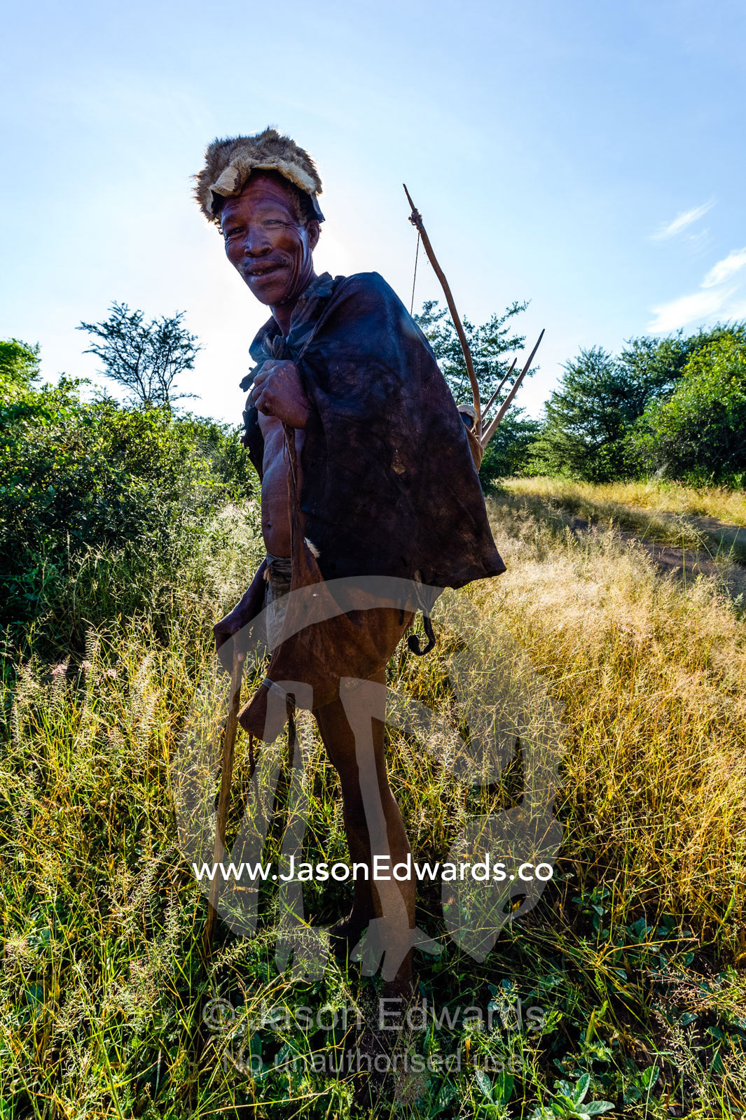 A San Bushmen carrying his bow and arrow quiver. Kalahari Desert, Botswana.