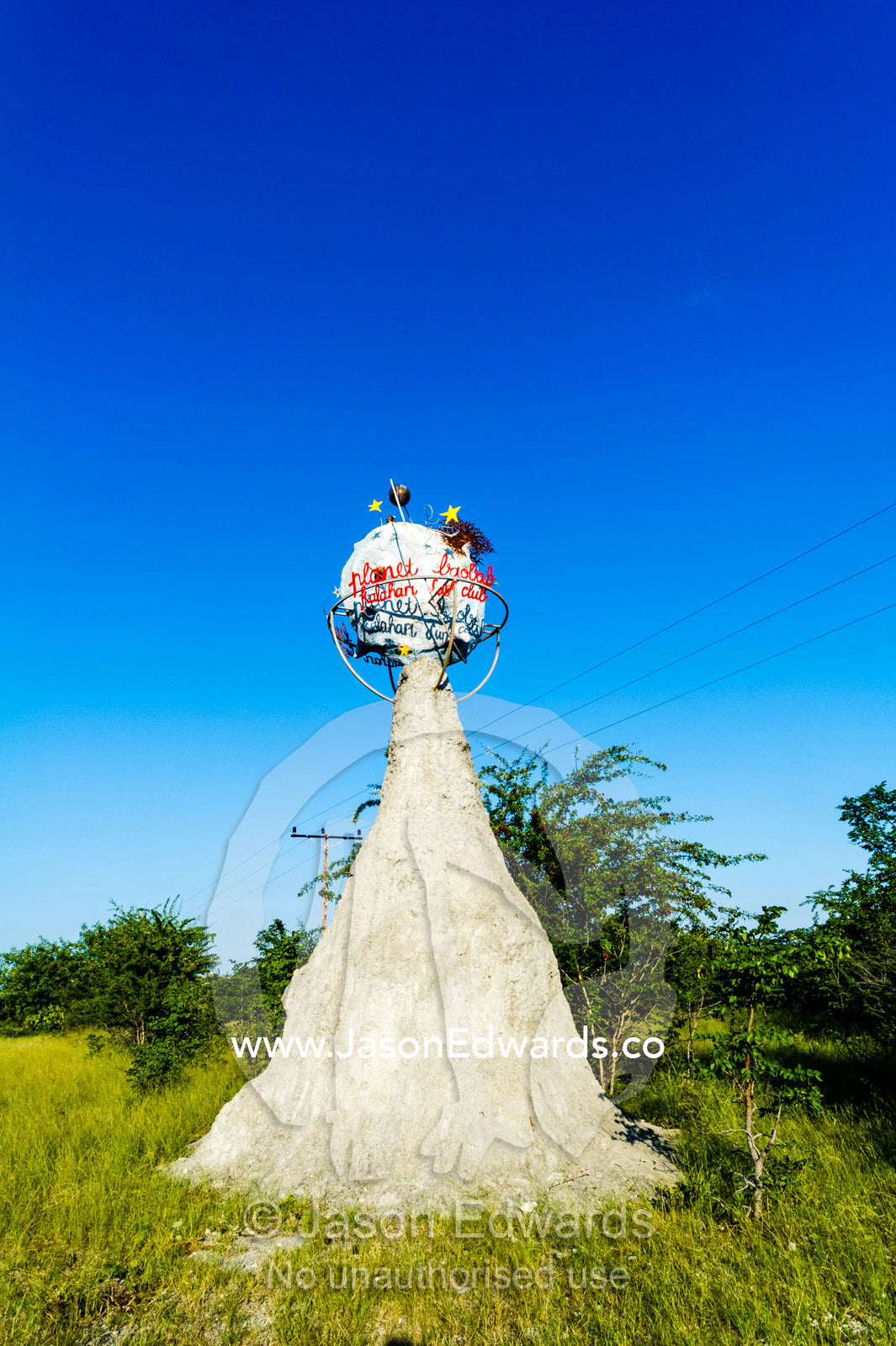 A Planet Baobab sign on an artificial termite mound. Planet Baobab, Makgadikgadi Pans, Botswana.