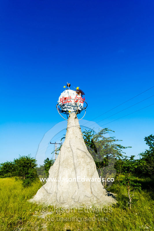 A Planet Baobab sign on an artificial termite mound. Planet Baobab, Makgadikgadi Pans, Botswana.
