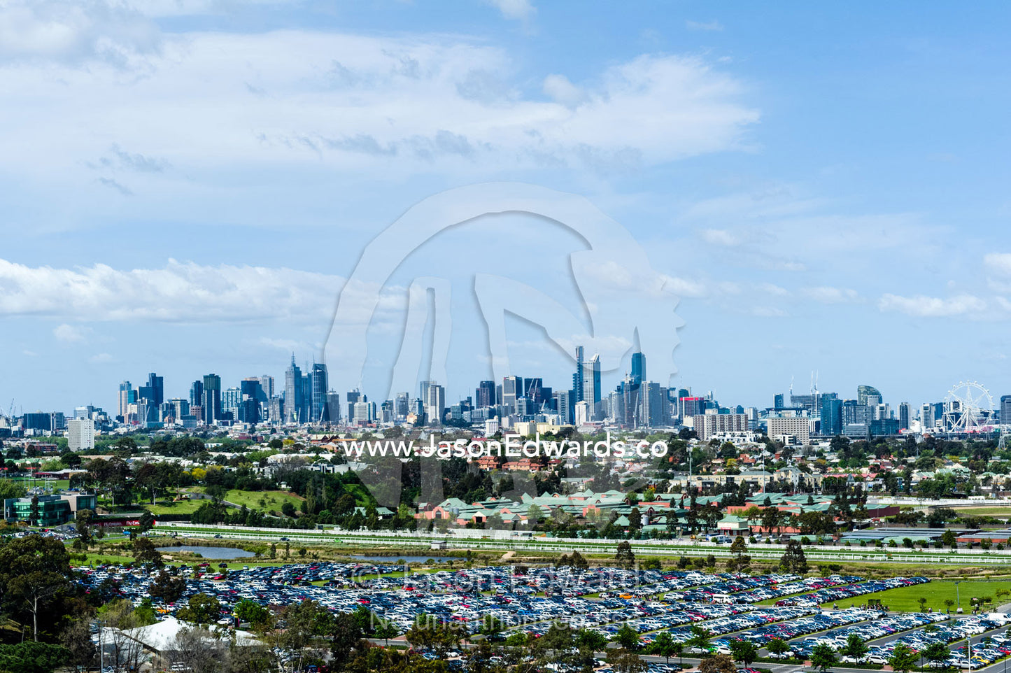 A car park full of traffic at an agricultural show with the city skyline in the background. Royal Melbourne Show, Flemington, Melbourne, Victoria, Australia.