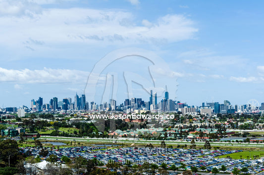 A car park full of traffic at an agricultural show with the city skyline in the background. Royal Melbourne Show, Flemington, Melbourne, Victoria, Australia.