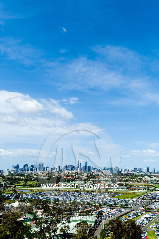 A car park full of traffic at an agricultural show with the city skyline in the background. Royal Melbourne Show, Flemington, Melbourne, Victoria, Australia.