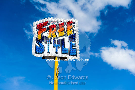 A colorful freestyle sign with light bulbs at an agricultural show. Royal Melbourne Show, Flemington, Melbourne, Victoria, Australia.