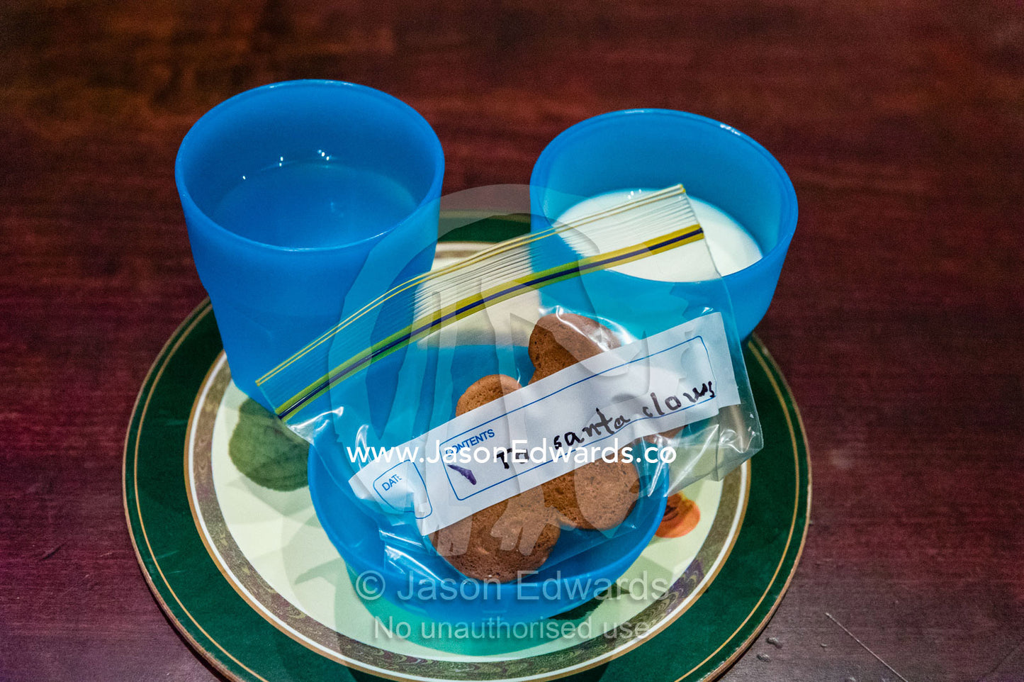 A cup of milk, water and gingerbread man biscuit for Santa on Christmas eve. Carlton North, Melbourne, Victoria, Australia.