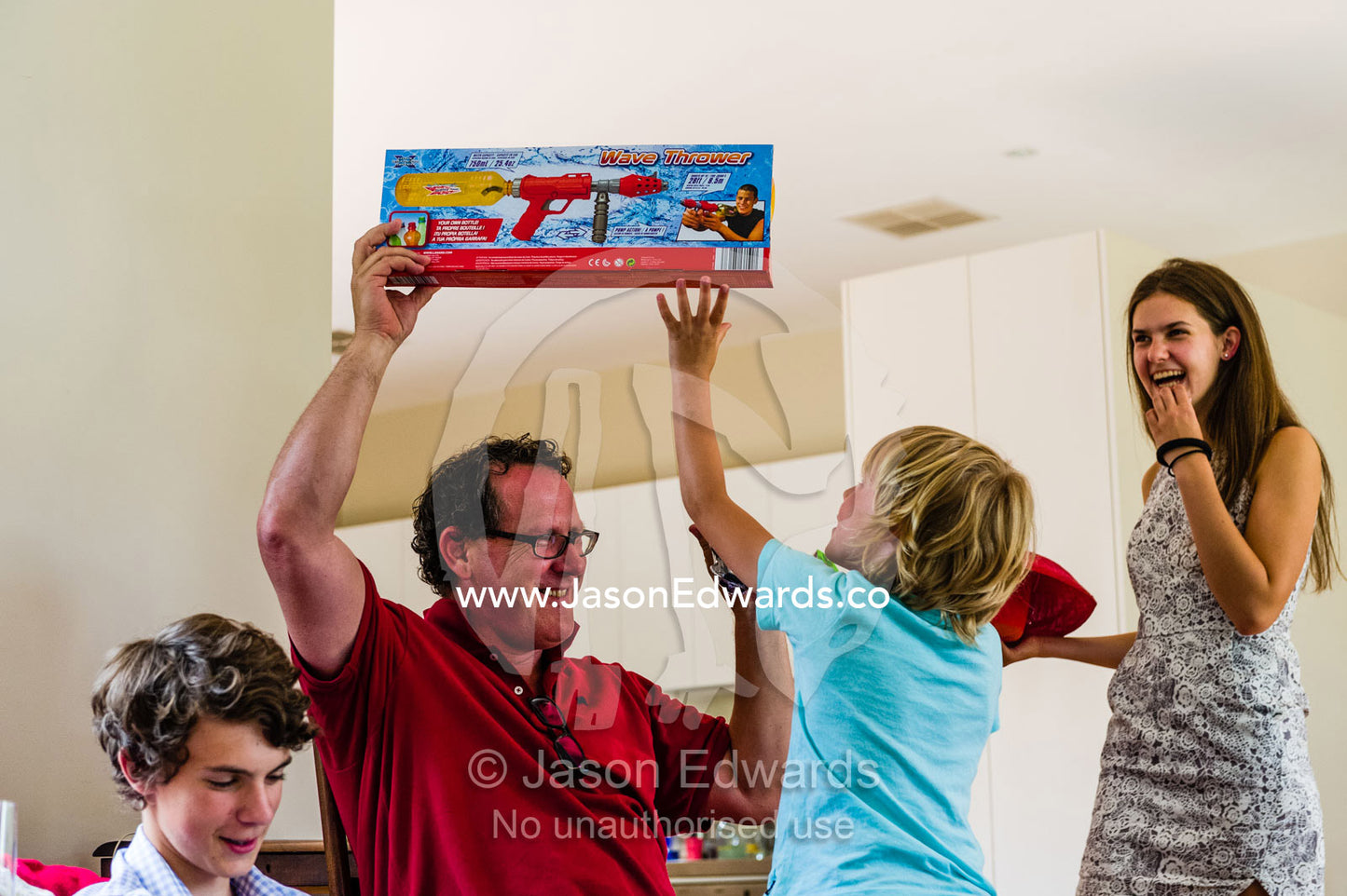 A family plays Kris Kringle on Christmas day where gifts are competitively exchanged for fun. Malvern East, Melbourne, Victoria, Australia.