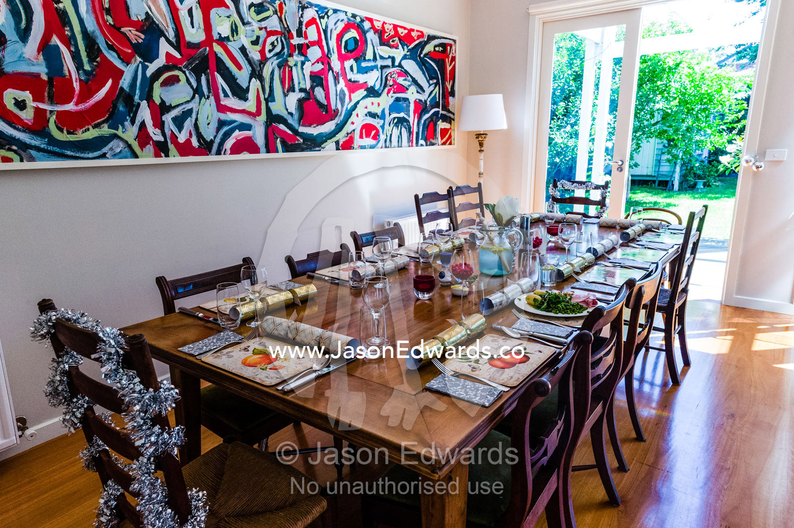 A dining table set for Christmas day lunch with bon bon crackers. Malvern East, Melbourne, Victoria, Australia.