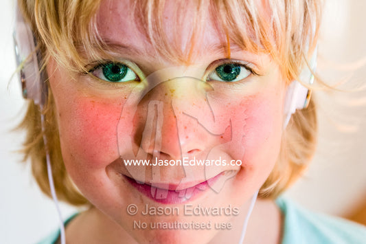 A boys face covered in a prism of rainbow colors through a window. Malvern East, Melbourne, Victoria, Australia.