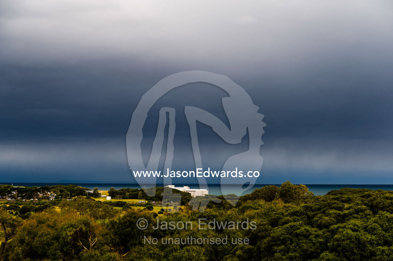 A storm rolls in from the ocean over a golf course. Torquay, Surf Coast, Victoria, Australia.