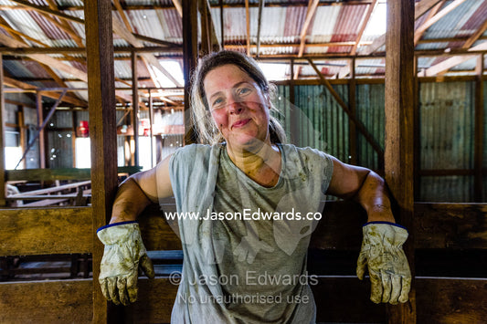A farmer rests in a shearing shed after a hard day working sheep. Euroa, Strathbogie, Victoria, Australia.