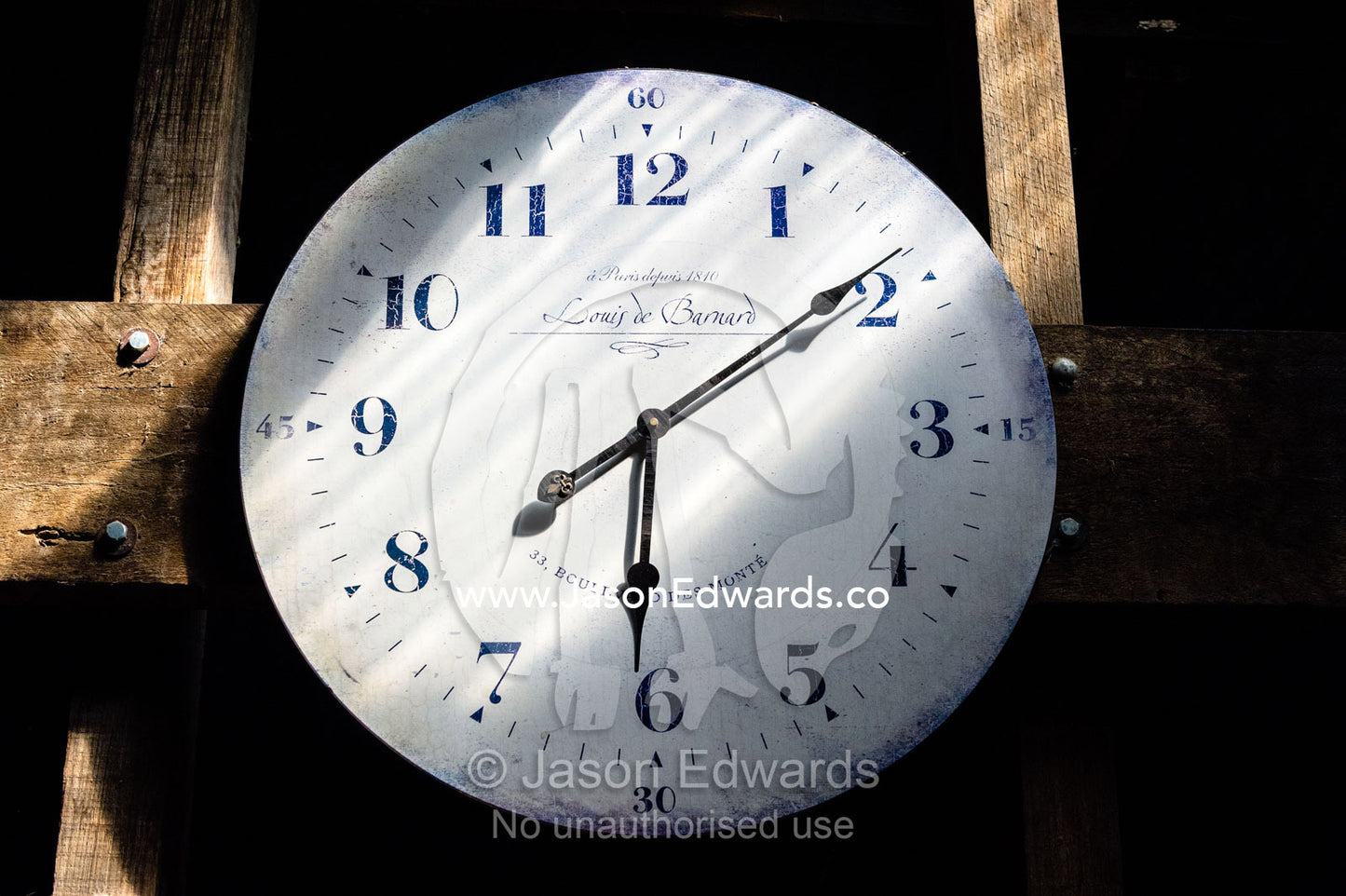 A ran of sunlight falls across a clock face in a sheep shearing shed. Euroa, Strathbogie, Victoria, Australia.