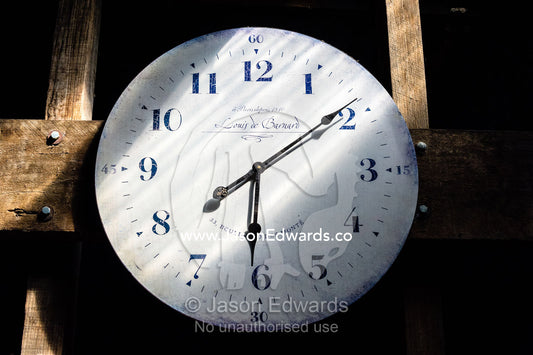 A ran of sunlight falls across a clock face in a sheep shearing shed. Euroa, Strathbogie, Victoria, Australia.
