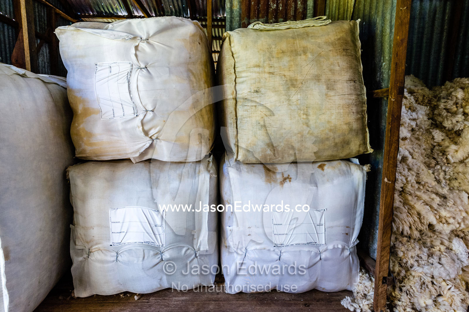 Bales of sheep wool in a shearing shed. Euroa, Strathbogie, Victoria, Australia.