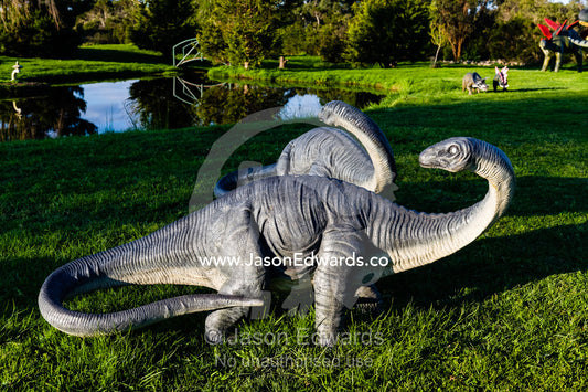 A pair of model Brachiosaurus dinosaurs in a garden. Devon Meadows, Melbourne, Victoria, Australia.