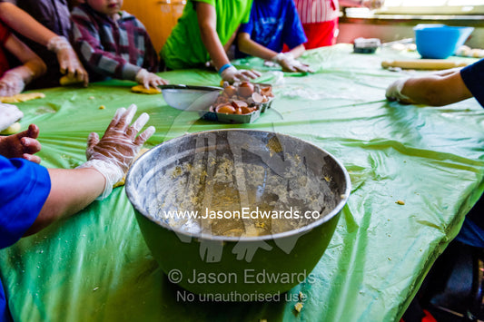 School children making pasta wearing food safe disposable gloves and a stainless steel bowl. Carlton North, Melbourne, Victoria, Australia.