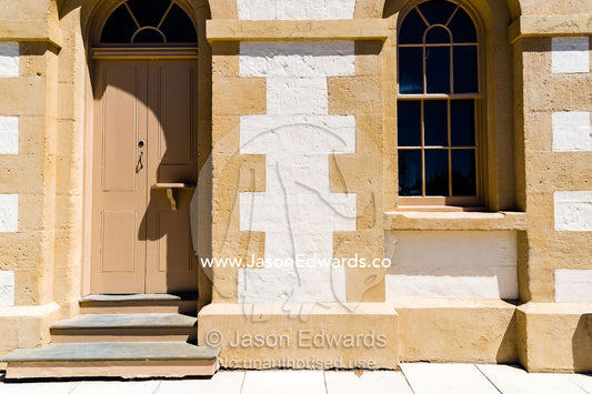 The doorway of an antique heritage limestone bank in a rural town. The Pennant, Penola, South Australia.