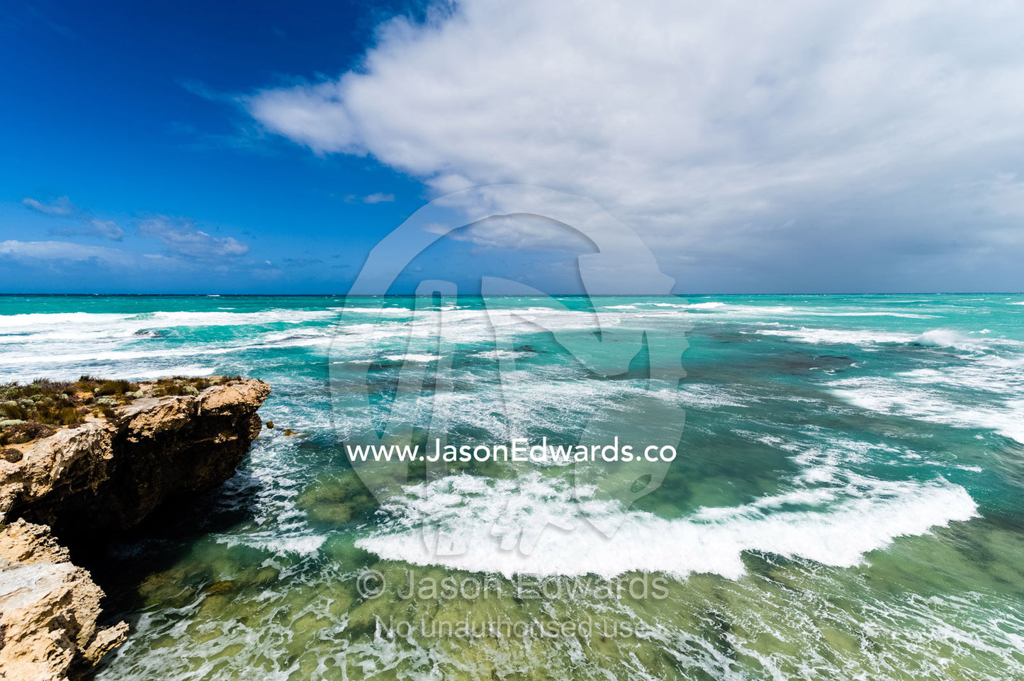 Strong winds whipping waves onto a rugged limestone coastline. Robe, Limestone Coast, South Australia, Australia.