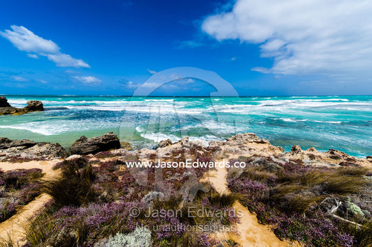 Strong winds whipping waves onto a rugged limestone coastline. Robe, Limestone Coast, South Australia, Australia.