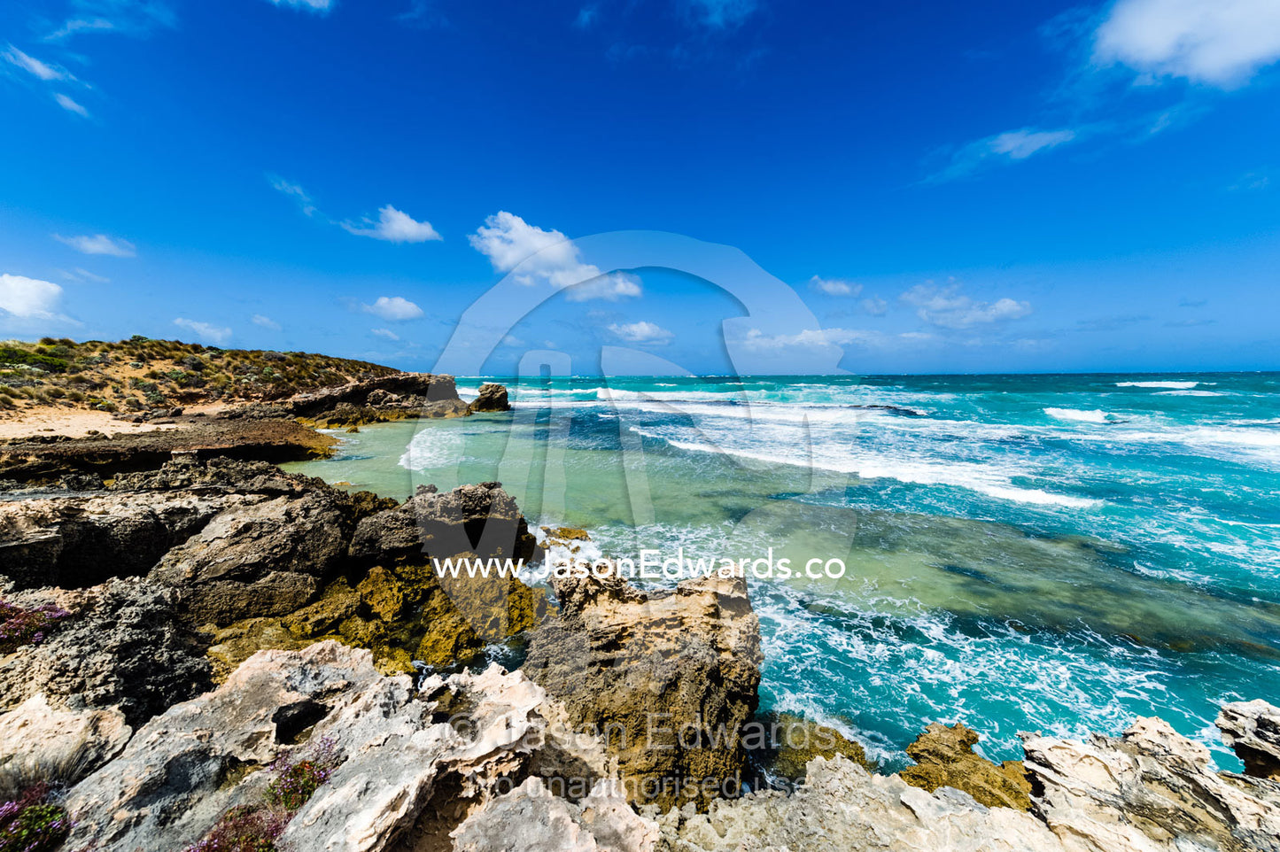 Strong winds whipping waves onto a rugged limestone coastline. Robe, Limestone Coast, South Australia, Australia.