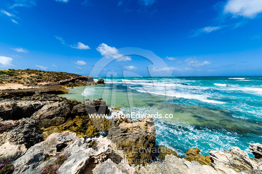 Strong winds whipping waves onto a rugged limestone coastline. Robe, Limestone Coast, South Australia, Australia.