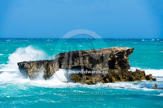 Strong winds whipping waves crashing onto a rugged limestone coastline. Robe, Limestone Coast, South Australia, Australia.