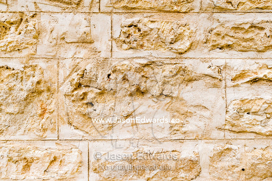 The detail of the bricks in the limestone wall of a church in a rural town. Robe, Limestone Coast, South Australia, Australia.