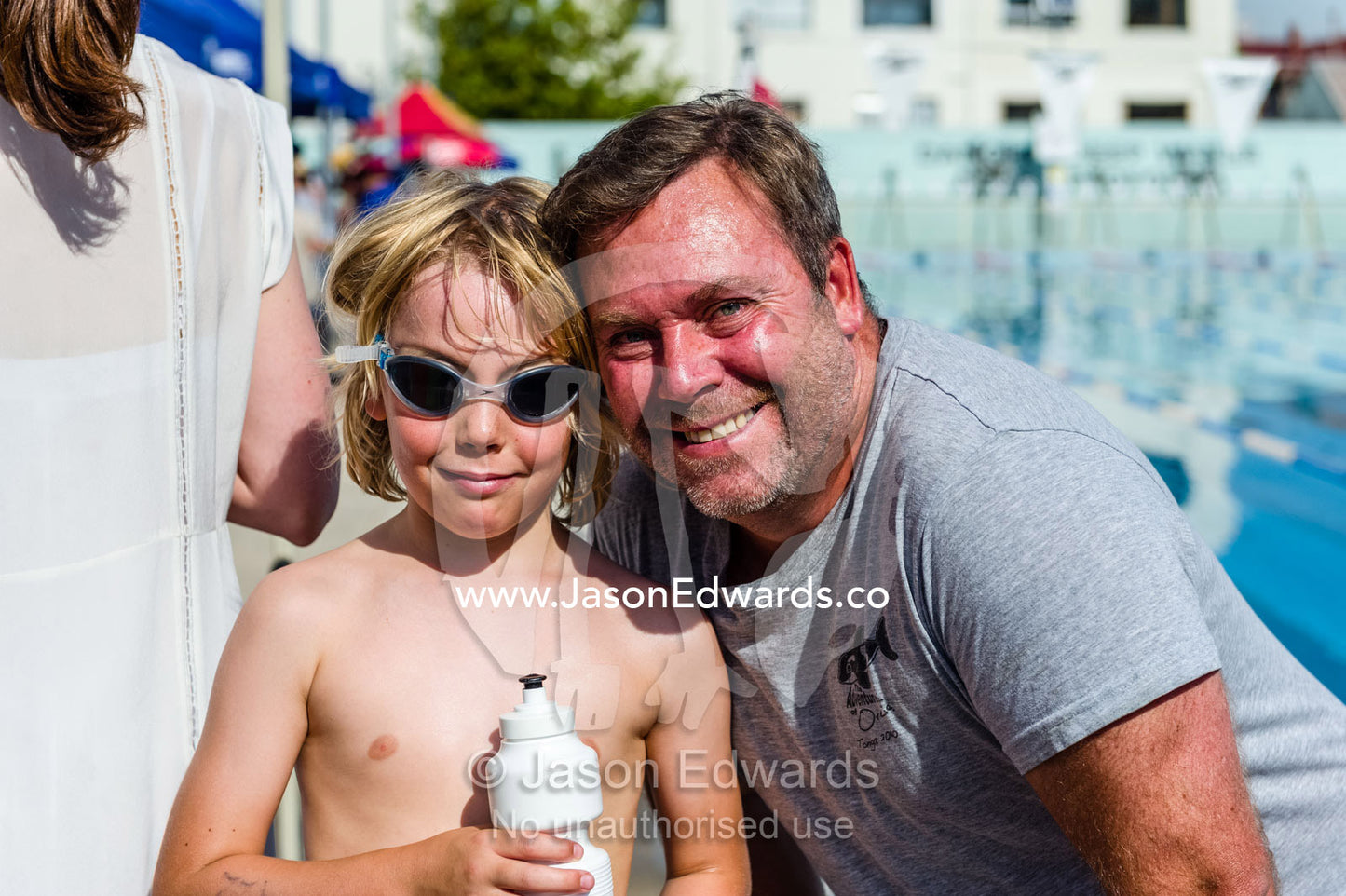 A father and son at a school swimming carnival. Fitzroy, Melbourne, Victoria, Australia.