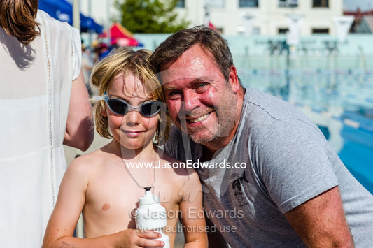 A father and son at a school swimming carnival. Fitzroy, Melbourne, Victoria, Australia.