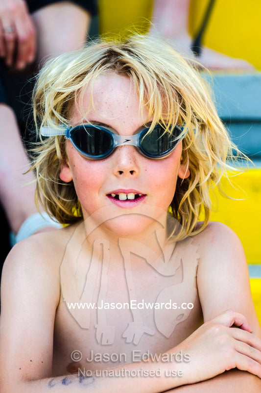A boy wearing goggles at a school swimming carnival. Fitzroy, Melbourne, Victoria, Australia.