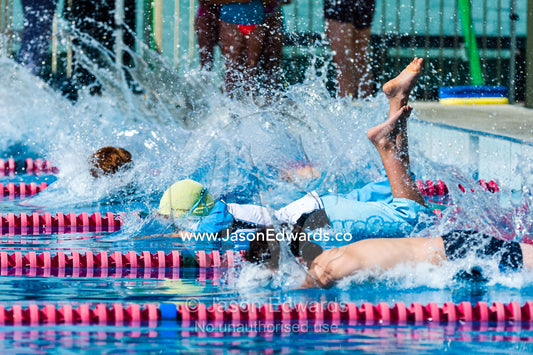 Students competing in races at a school swimming carnival. Fitzroy, Melbourne, Victoria, Australia.