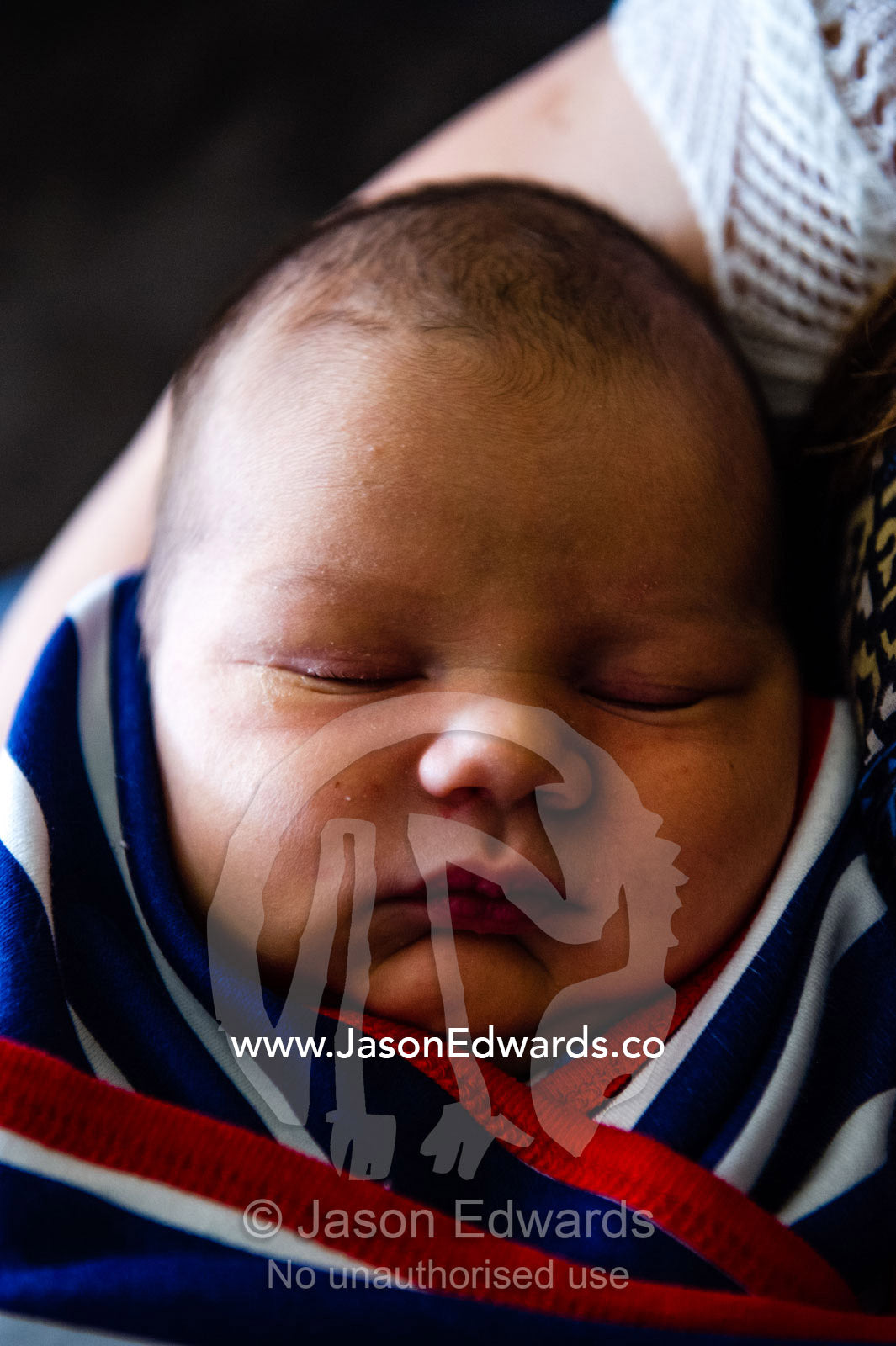 A sleeping baby wrapped in a bundle. Cooranbong, New South Wales, Australia.
