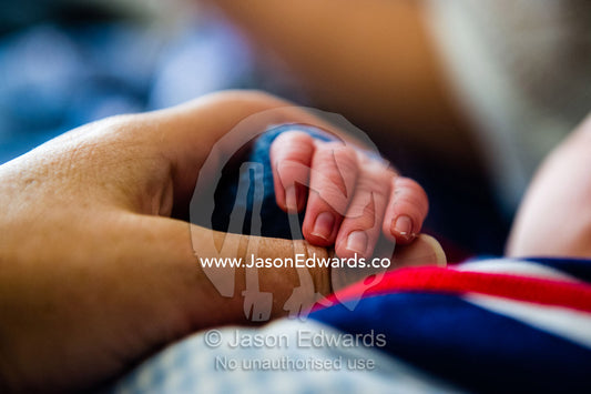The tiny fingers of a small baby wrapped in a bundle. Cooranbong, New South Wales, Australia.