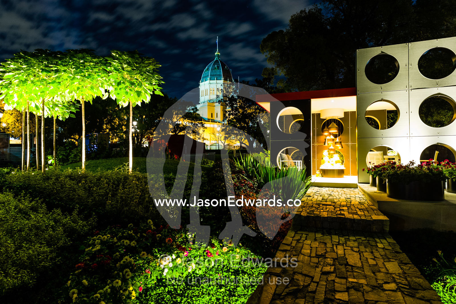 An architecturally designed outdoor patio and garden setting with spotlights at a garden show. Melbourne International Flower and Garden Show, Carlton Gardens, Carlton, Melbourne, Victoria, Australia.