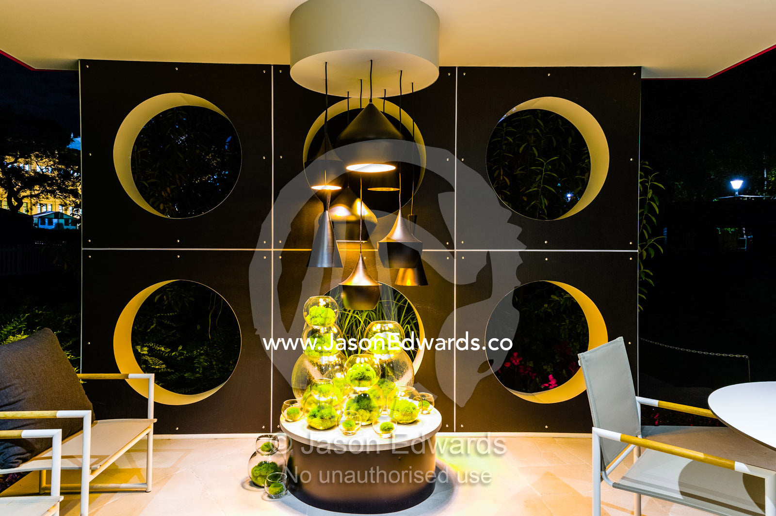 An architecturally designed outdoor patio and garden setting with spotlights at a garden show. Melbourne International Flower and Garden Show, Carlton Gardens, Carlton, Melbourne, Victoria, Australia.