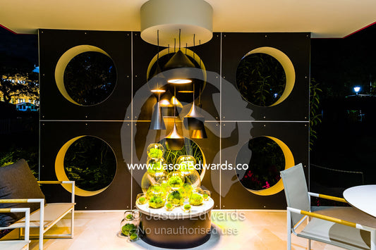 An architecturally designed outdoor patio and garden setting with spotlights at a garden show. Melbourne International Flower and Garden Show, Carlton Gardens, Carlton, Melbourne, Victoria, Australia.